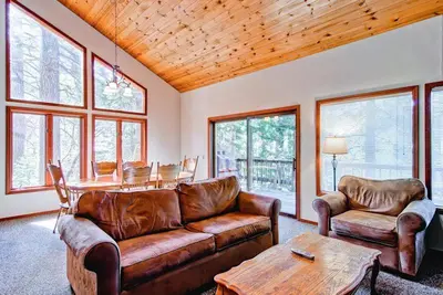 a living room with a leather couch and a table at Sport Chalet in Yosemite West