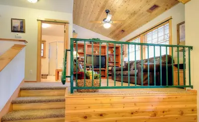 a living room with a staircase leading up to a house at Strawberry Creek in Yosemite West