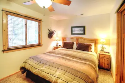 a bedroom with a bed and a large window at Strawberry Creek in Yosemite West