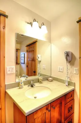 a bathroom with a sink and a large mirror at Strawberry Creek in Yosemite West