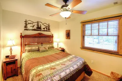 a bedroom with a bed and a ceiling fan at Strawberry Creek in Yosemite West