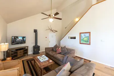 a living room with couches and a ceiling fan at Yosemite Park Place in Yosemite West