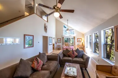 a living room with couches and a ceiling fan at Yosemite Park Place in Yosemite West