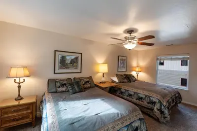 a bedroom with two beds and a ceiling fan at Starlight Lodge in Yosemite West