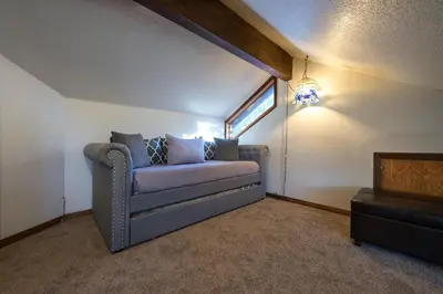 a living room with a couch and a window at Four Seasons in Yosemite West