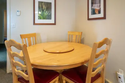 a wooden table with four chairs around it at Falcons Nest (Downstairs) in Yosemite West