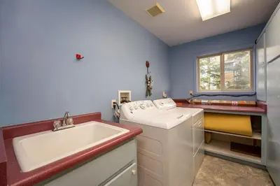 a laundry room with a sink and a washing machine at Falcons Nest (Downstairs) in Yosemite West