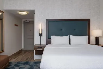 a bedroom with a large bed with a blue headboard at Hampton Inn by Hilton Turlock in Turlock