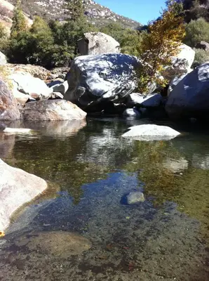 a stream of water with rocks and a mountain at Alta Peak Vista in Three Rivers