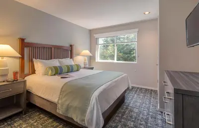 a bedroom with a large bed and a window at WorldMark Bass Lake in Bass Lake