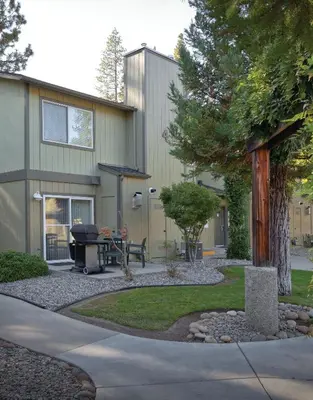 a backyard with a grill and a house at WorldMark Bass Lake in Bass Lake