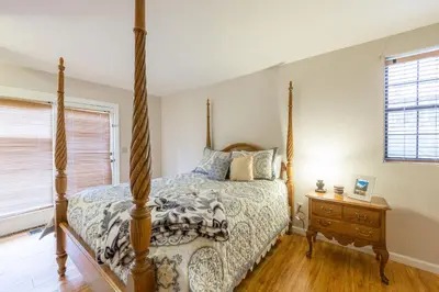 a bedroom with a four poster bed and a night stand at Yosemite Sierra Blossom in Yosemite West