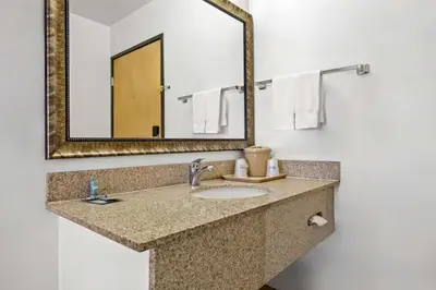 a bathroom with a sink and a mirror at Best Western Liberty Inn in Delano
