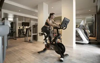 a woman riding an exercise bike in a gym at Edgewood Tahoe Resort in Stateline