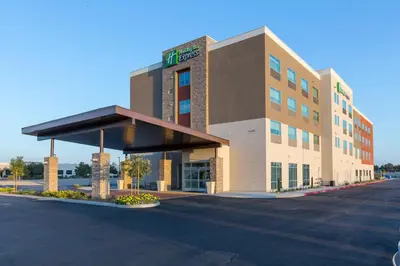 a hotel building with a parking lot in front of it at Holiday Inn Express Visalia-Sequoia Gateway Area by IHG in Visalia