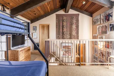 a room with a bunk bed and a tv at Chamonix # 92 in Mammoth Lakes
