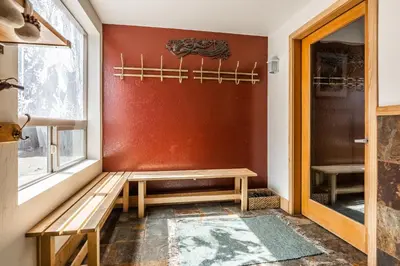 a room with a wooden bench next to a window at Chamonix # 92 in Mammoth Lakes