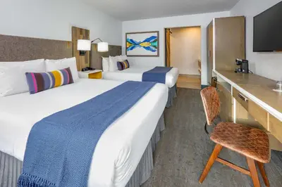 a hotel room with two beds and a desk at Hotel Becket, BW Signature Collection in South Lake Tahoe