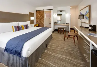 a hotel room with a large bed and a desk at Hotel Becket, BW Signature Collection in South Lake Tahoe