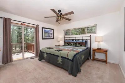 a bedroom with a bed and a ceiling fan at Evergreen in Wawona
