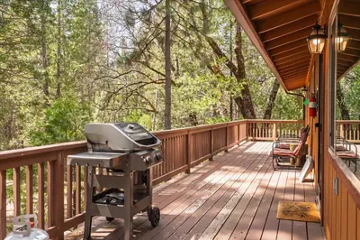 a grill on a deck on a house at Evergreen in Wawona