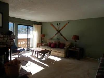 a living room with a couch and a large clock on the wall at Rr-interlaken 29 in June Lake