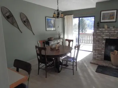 a dining room with a table and a fireplace at Rr-interlaken 29 in June Lake