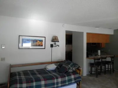 a bedroom with a bed and a table in it at Rr-interlaken 29 in June Lake