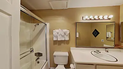 a bathroom with a toilet and a sink and a shower at Spacious 3 Bedroom Condo with Loft! in Mammoth Lakes