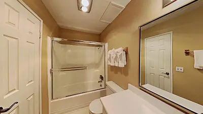 a bathroom with a shower and a toilet and a mirror at Spacious 3 Bedroom Condo with Loft! in Mammoth Lakes