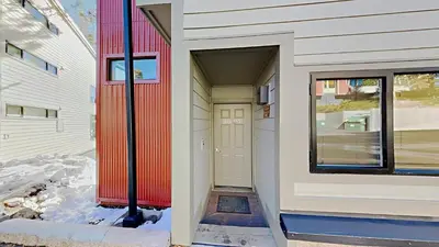 a house with a red door on the side of it at Spacious 3 Bedroom Condo with Loft! in Mammoth Lakes