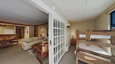 a bedroom with a bunk bed and a living room at Lakeview 826 Condo #108 Condo in Mammoth Lakes