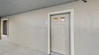 a white door on the side of a building at Lakeview 826 Condo #108 Condo in Mammoth Lakes