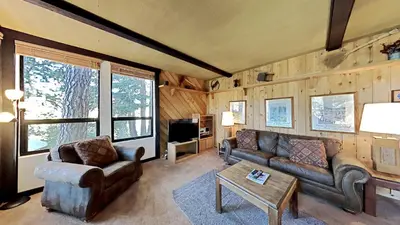 a living room with a couch and a table at Spacious 2 Bedroom Condo with Mountain View! in Mammoth Lakes