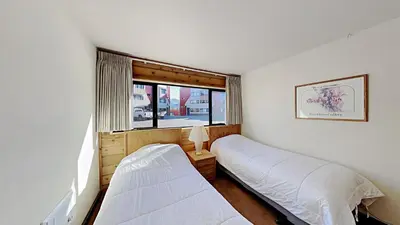 a bedroom with two beds and a window at Spacious 2 Bedroom Condo with Mountain View! in Mammoth Lakes