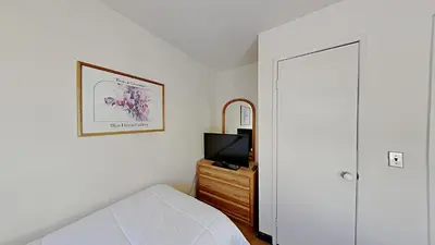 a bedroom with a bed and a television on a dresser at Spacious 2 Bedroom Condo with Mountain View! in Mammoth Lakes