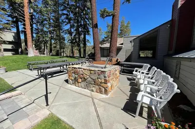 a group of picnic tables and chairs on a patio at Spacious Condo Great For Friends And Families! in Mammoth Lakes