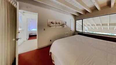 a bedroom with a bed and a large window at Comfortable 4 Bedroom Condo in Mammoth Lakes
