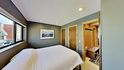 a bedroom with a white bed and a window at Beautifully remodeled 3 Bedroom Condo in Mammoth Lakes