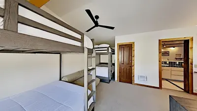 a bedroom with bunk beds and a ceiling fan at Beautifully remodeled 3 Bedroom Condo in Mammoth Lakes