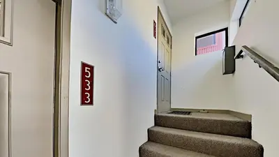a stairway with a exit sign on the wall at Beautifully remodeled 3 Bedroom Condo in Mammoth Lakes
