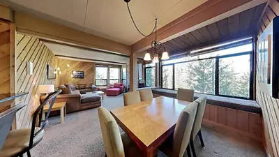 a dining room and living room with a table and chairs at Lakeview 826 Condo #553 Condo in Mammoth Lakes