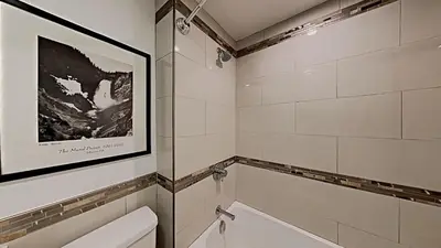 a bathroom with a toilet and a picture on the wall at Spacious 2 Bedroom Condo in Mammoth Lakes