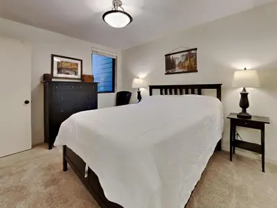 a bedroom with a large white bed and a dresser at Walk To Lifts! Remodeled 2 Bedroom Condo in Mammoth Lakes