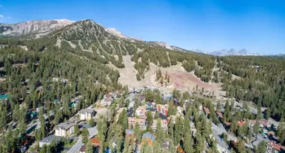 an aerial view of a mountain with trees and buildings at Walk To Lifts! Remodeled 2 Bedroom Condo in Mammoth Lakes