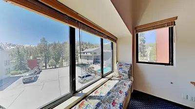 a room with a couch and a large window at Remodeled Spacious Cozy Condo Great For Families! in Mammoth Lakes
