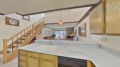 a kitchen with a sink and a living room at Comfortable Cozy 2 Bedroom Condo with Loft! in Mammoth Lakes