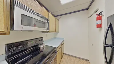 a kitchen with a stove and a microwave at Comfortable Cozy 2 Bedroom Condo with Loft! in Mammoth Lakes