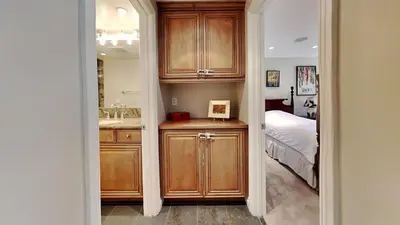 a kitchen with wooden cabinets and a bed in a room at Beautiful 2 Bedroom Condo with Amazing View! in Mammoth Lakes