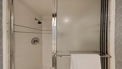 a bathroom with a shower with a white towel at Retro 3 Bed 3 Bath Condo with Mountain View! in Mammoth Lakes